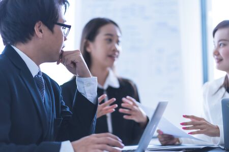 Group of business people busy discussing financial matter during meeting. Asian peopleの写真素材