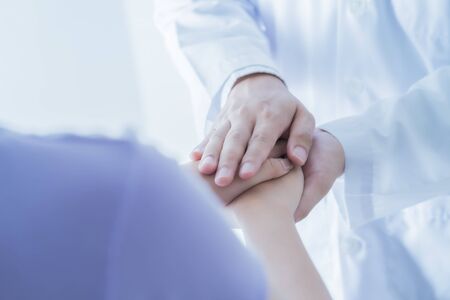 male doctor comforting patient at consulting room. Asian peopleの写真素材