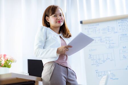 Young woman working at home or in a small office. Asian Peopleの写真素材