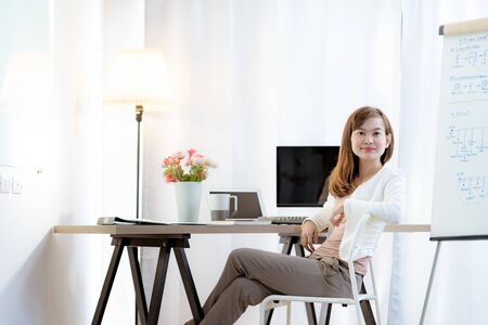 Young woman working at home or in a small office. Asian Peopleの写真素材