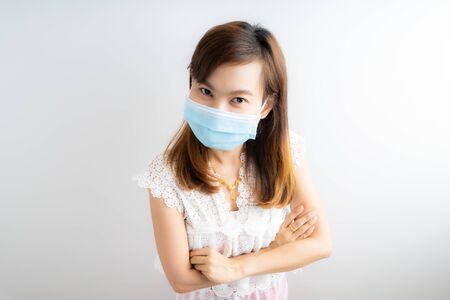 Close up portrait of young woman with medicine health care mask against white white background. CoronaVirus, Covid-19. Asian peopleの写真素材