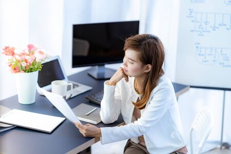 Young woman working at home or in a small office. Asian Peopleの写真素材
