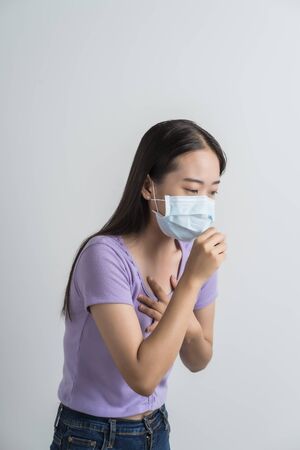 Close up portrait of young woman with medicine health care mask against white white background. CoronaVirus, Covid-19. Asian peopleの写真素材