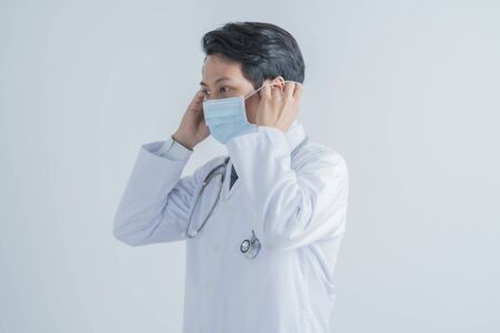 Doctor wearing protection face mask against coronavirus.Asian peopleの写真素材