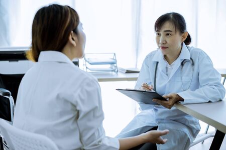 Female doctor consulting patient. Asian peopleの写真素材