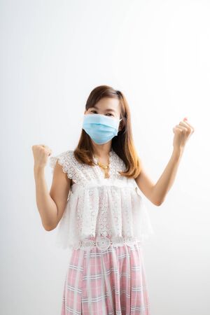 Close up portrait of young woman with medicine health care mask against white white background. CoronaVirus, Covid-19. Asian peopleの写真素材