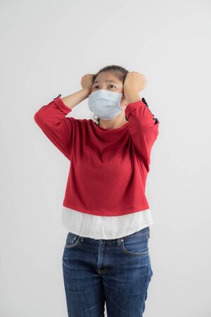 Close up portrait of young woman with medicine health care mask against white white background. CoronaVirus, Covid-19. Asian peopleの写真素材