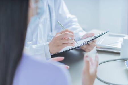 Doctors and patient talking about therapy. Asian peopleの写真素材