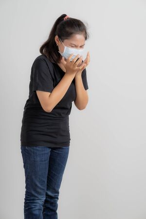 Close up portrait of young woman with medicine health care mask against white white background. CoronaVirus, Covid-19. Asian peopleの写真素材