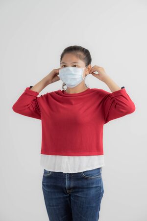 Close up portrait of young woman with medicine health care mask against white white background. CoronaVirus, Covid-19. Asian peopleの写真素材