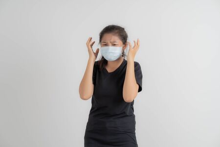 Close up portrait of young woman with medicine health care mask against white white background. CoronaVirus, Covid-19. Asian peopleの写真素材