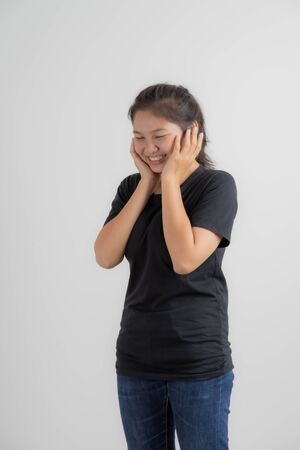 Do not miss. Young asian woman shouting. Shout. Crying emotional woman screaming on pink studio background. Female half-length portrait. Human emotions, facial expression concept. Trendy. Asian peopleの写真素材