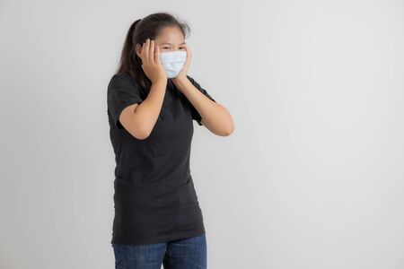 Close up portrait of young woman with medicine health care mask against white white background. CoronaVirus, Covid-19. Asian peopleの写真素材