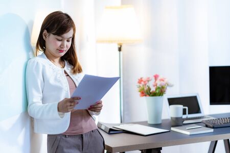 Young woman working at home or in a small office. Asian Peopleの写真素材