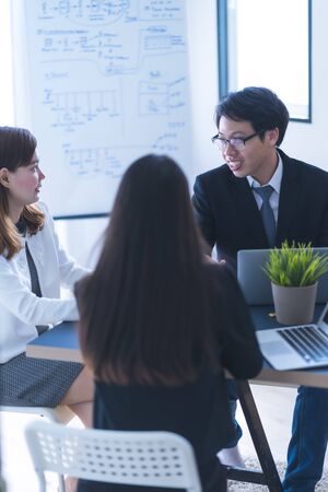 Group of business people busy discussing financial matter during meeting. Asian peopleの写真素材