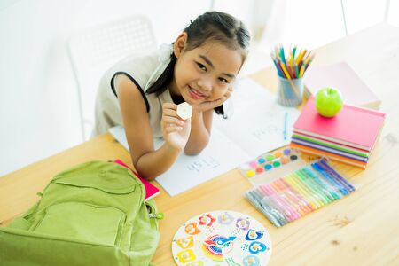 Asian cute little child girl drawing at homeの写真素材