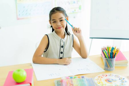 Asian cute little child girl drawing at homeの写真素材