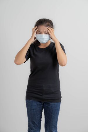 Close up portrait of young woman with medicine health care mask against white white background. CoronaVirus, Covid-19. Asian peopleの写真素材