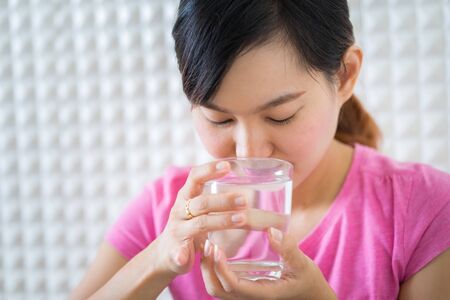 Female drinking from a glass of water. Health care conceptの写真素材