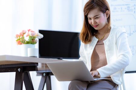 Young woman working at home or in a small office. Asian Peopleの写真素材
