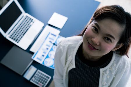 Business women reviewing data in financial statement. Accountingの写真素材
