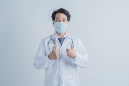 Doctor wearing protection face mask against coronavirus.Asian peopleの写真素材