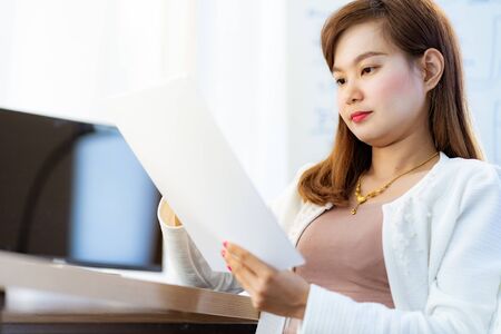 Young woman working at home or in a small office. Asian Peopleの写真素材