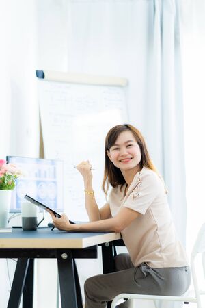Young asia woman working at home or in a small office. Asian peopleの写真素材