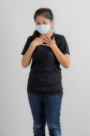 Close up portrait of young woman with medicine health care mask against white white background. CoronaVirus, Covid-19. Asian peopleの写真素材
