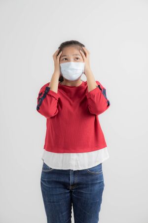 Close up portrait of young woman with medicine health care mask against white white background. CoronaVirus, Covid-19. Asian peopleの写真素材