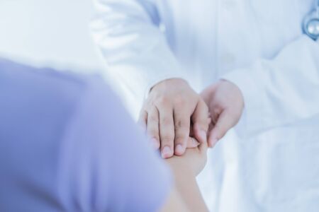 male doctor comforting patient at consulting room. Asian peopleの写真素材