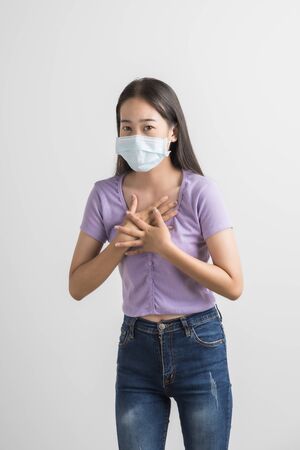 Close up portrait of young woman with medicine health care mask against white white background. CoronaVirus, Covid-19. Asian peopleの写真素材