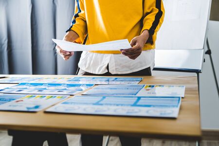 Asian business woman reviewing data in financial charts and graphs. Accountingの写真素材