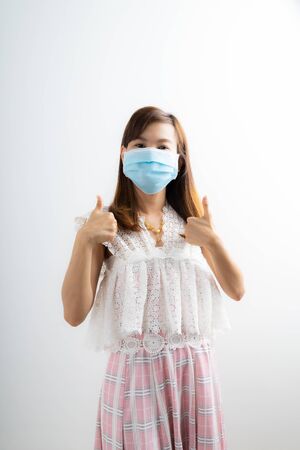 Close up portrait of young woman with medicine health care mask against white white background. CoronaVirus, Covid-19. Asian peopleの写真素材