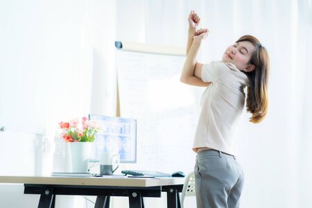 Business woman with back pain in office. Asian people. Work at home conceptの写真素材