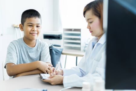 Asian little boy visiting a doctor. Medicine and children's therapy conceptの写真素材