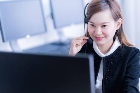 Asian young woman working in call centreの写真素材