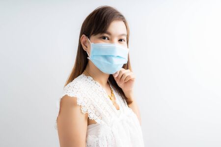 Close up portrait of young woman with medicine health care mask against white white background. CoronaVirus, Covid-19. Asian peopleの写真素材