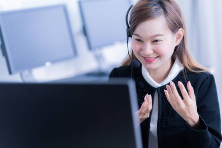 Asian young woman working in call centreの写真素材