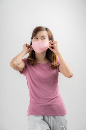 Close up portrait of young woman with medicine health care mask against white white background. CoronaVirus, Covid-19. Asian peopleの写真素材