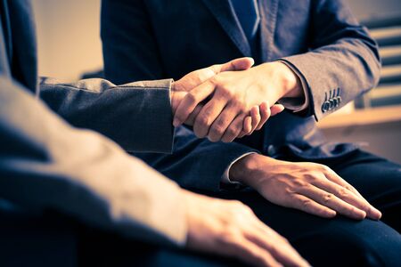Businessman shaking hands to seal a deal with his partnerの写真素材