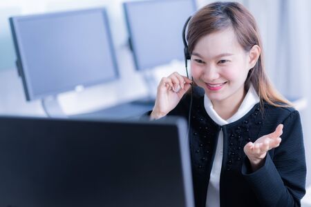 Asian young woman working in call centreの写真素材