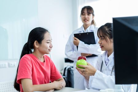 Female doctor consulting patient. Asian peopleの写真素材
