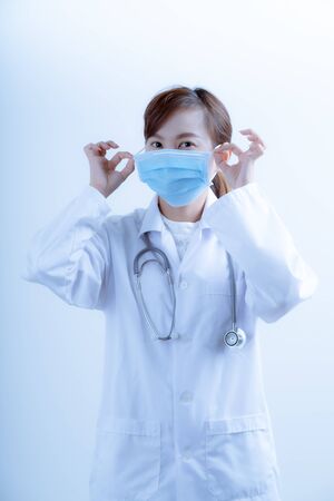 Doctor woman wearing protection face mask against coronavirus.Asian peopleの写真素材