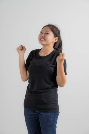 Do not miss. Young asian woman shouting. Shout. Crying emotional woman screaming on pink studio background. Female half-length portrait. Human emotions, facial expression concept. Trendy. Asian peopleの写真素材