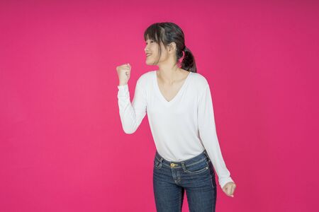 I won. Winning success happy woman celebrating being a winner. Dynamic image of caucasian female model on pink studio background. Victory, delight concept. Human facial emotions concept. Trendy colorsの写真素材