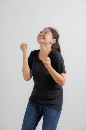 Do not miss. Young asian woman shouting. Shout. Crying emotional woman screaming on pink studio background. Female half-length portrait. Human emotions, facial expression concept. Trendy. Asian peopleの写真素材