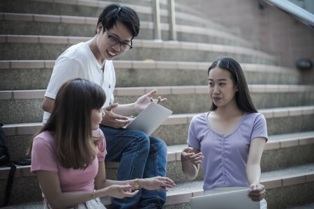 Group of happy teen high school students outdoors. Asian peopleの写真素材