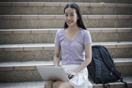 College asian student female sitting on staircase. Asian Peopleの写真素材