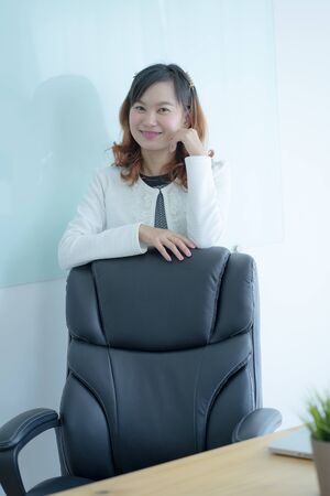 Asian business woman reviewing data in financial charts and graphs. Accountingの写真素材